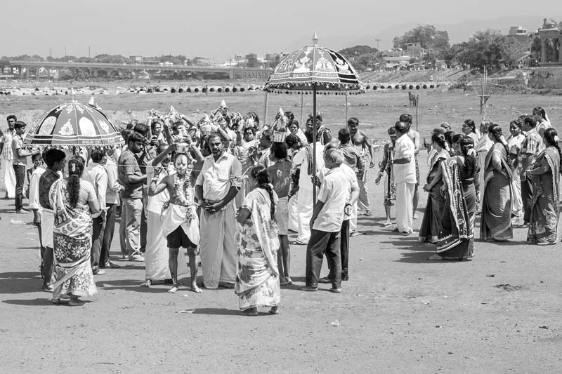 Challenges Impacting the Connection between Water and Religion - Devotees gathered for religious celebrations during Tamil month Aadi at the dried-up Vaiagi river bed in Madurai, Tamil Nadu